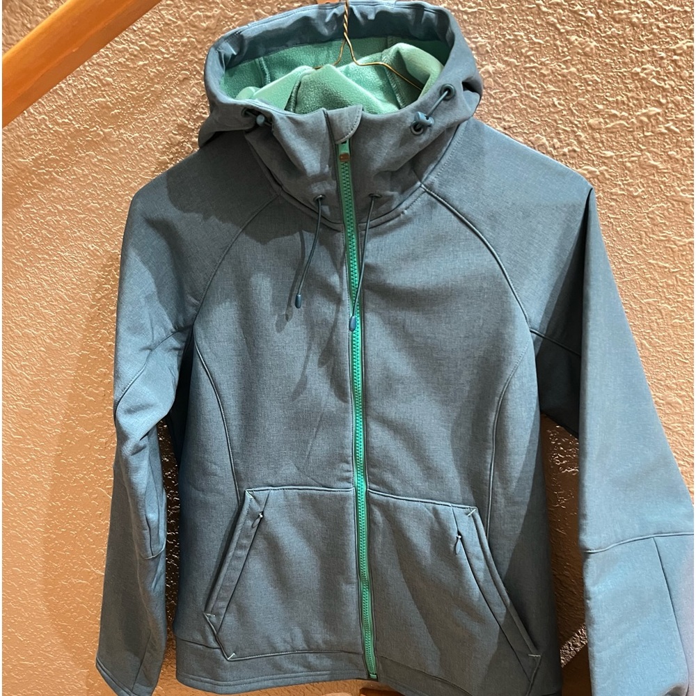 Never worn, SIMMS women’s fly fishing jacket. Brand New, Size Small.  Blue/Green